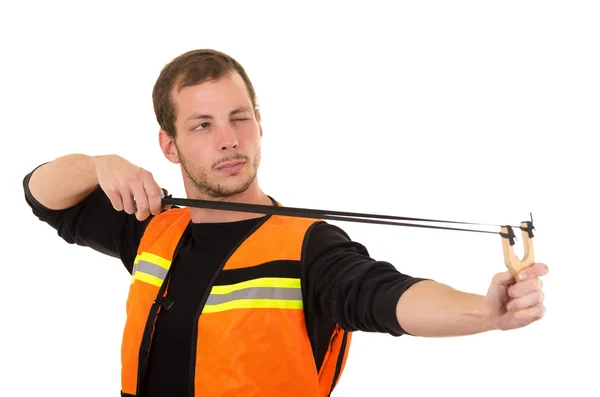 Handsome man concentrated aiming a slingshot with security vest isolated over white background — ストック写真