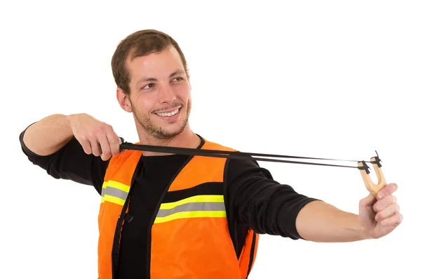 Handsome man concentrated aiming a slingshot with security vest isolated over white background — Zdjęcie stockowe
