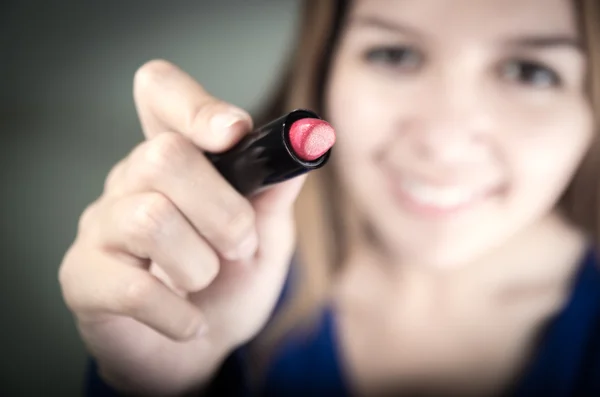 Beautiful young teen girl holding red lipstick — Stock Photo, Image