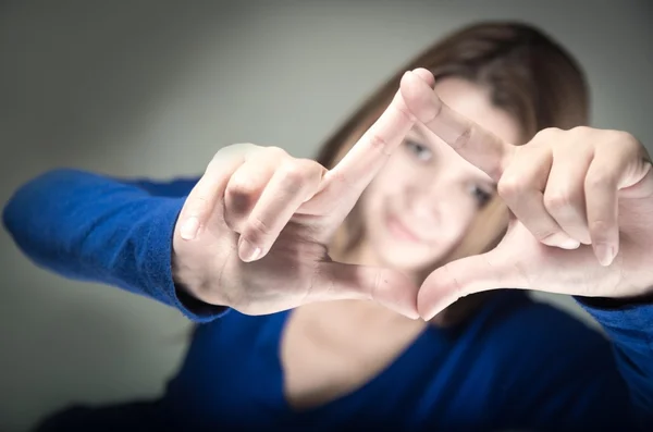 Closeup portrait of cute young teen girl making with fingers — Stock Photo, Image