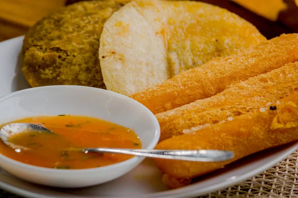 Closeup of mixed white platter with typical latin fried foods. abbas, cheese and salsa bowl delicately arranged rustic setting — Stock Photo, Image