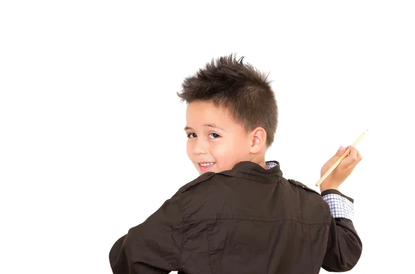 Kleine jongen achteruit, op zoek naar camera, tekening in de lucht, geïsoleerd op witte achtergrond — Stockfoto