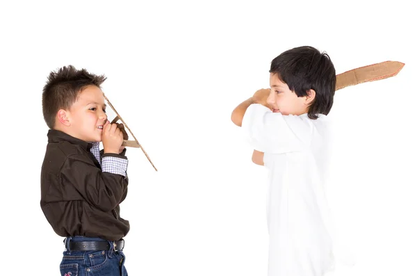 Two small boys simluating sword fight using toys and homemade shield, white background — Stock Photo, Image