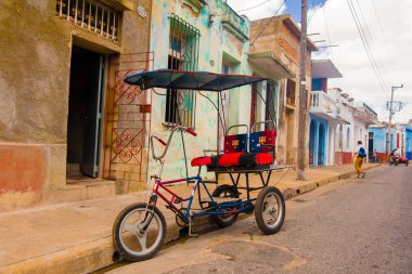 CAMAGUEY, CUBA - SEPTEMBER 4, 2015: bicitaxi is a modified bicycle used for transportation of tourists and goods as a taxi. clipart