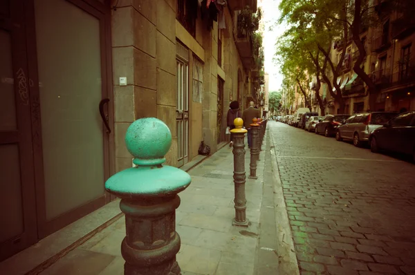 Decorative poles along street separating traffic from sidewalk downtown Barcelona — ストック写真