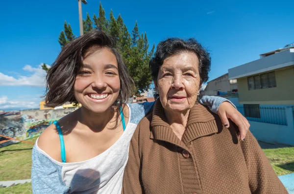 Lovely grandmother and granddaughter sitting together enjoying quality time outdoors — Stockfoto