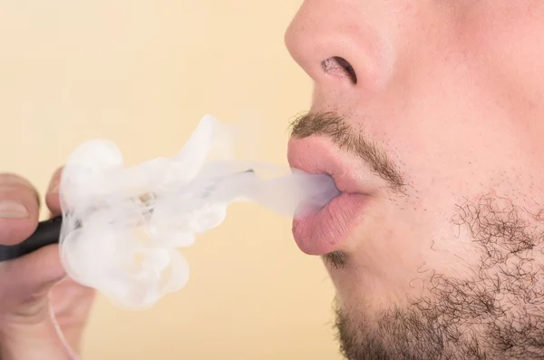 Closeup headshot of man smoking on electronic cigarette from profile angle — Stock Photo, Image