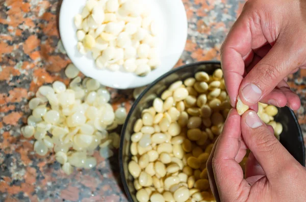 Closeup peeling, before and after bowls with lupini beans superfood, part of legum family, preparing fanesca concept — 图库照片