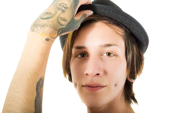 Headshot young hispanic male wearing black hat, red sleveless shirt with tattoos on chest and arms, punk rock insipired look, posing for camera — Stock Photo, Image