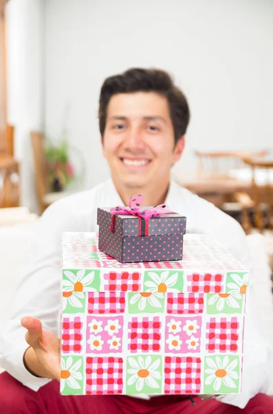 Bonito jovem alegre segurando caixa de presente de Natal — Fotografia de Stock