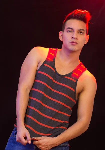 Hispanic male wearing red black striped singlet posing with serious facial expression — Stock Photo, Image