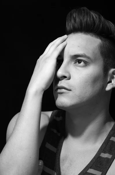 Hispanic male wearing striped singlet, covering half face with own hand, black and white edition — Stock Photo, Image