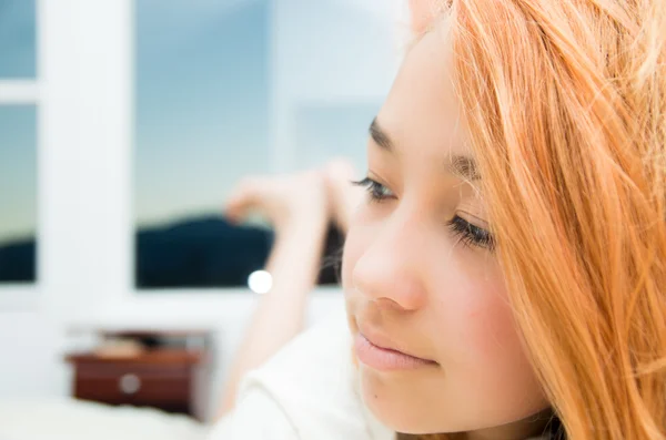 Pretty young woman headshot thoughtful closeup blurry large windows background — 图库照片