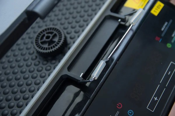 Print screen machine closeup with small black plastic wheel lying on bubble pattern surface — Stock Photo, Image