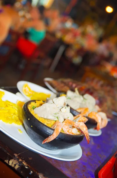 Hermoso plato de mariscos servido en un plato de sopa en un restaurante con fondo borroso , — Foto de Stock