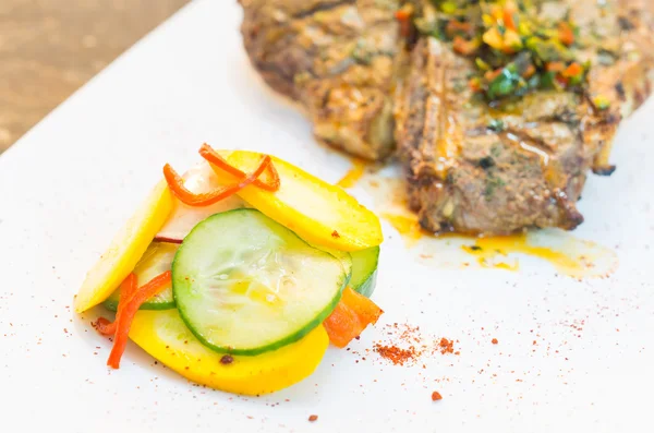 Beautifully cooked cutlet with chimichurri topping placed upon white plate, elegant presentation. — Stock Photo, Image