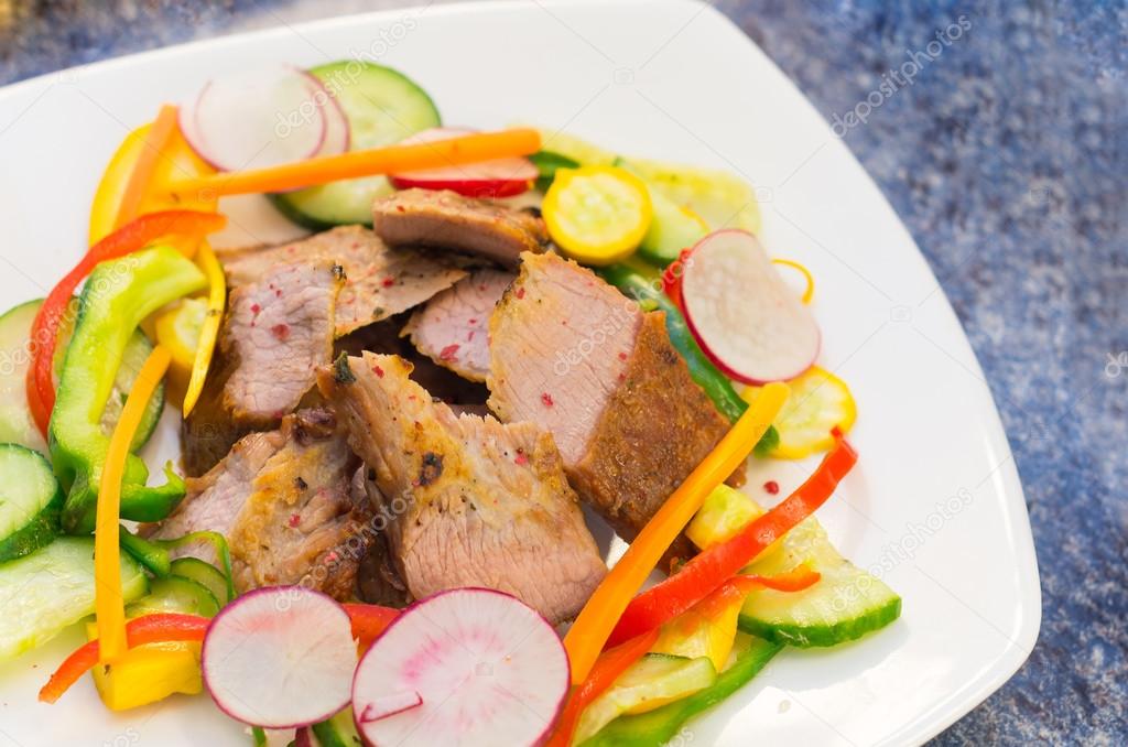 Delicious flank steak cuts cooked to perfection, mixed with reddish, zucchini and capsicum, elegant presentation