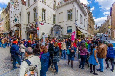 Brussels, Belçika - 11 Ağustos, 2015: kalabalık turist Manneken Pis ünlü dönüm noktası bronz heykel küçük çocuk çeşme, kutlamalar için mavi kahverengi şapkalı giymiş içine peeing gösterilen izlerken
