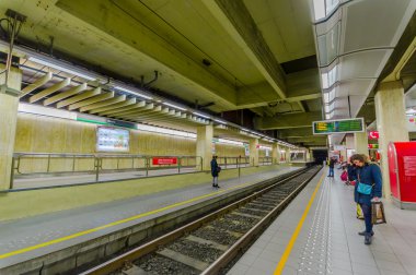 Brussels, Belçika - 11 Ağustos, 2015: Beurs içinde tren istasyonu platformu gösteren birkaç kişi bekliyor