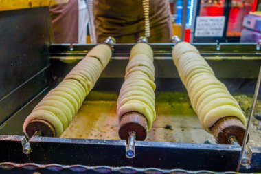 Prague, Czech Republic - 13 August, 2015: Many typical local donuts stored around a pole lying horizontally on display for customers
