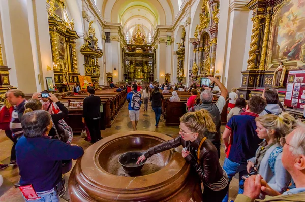 Prague, Czech Republic - 13 August, 2015: Inside amazing church of Castle Cathedral with massive water fountain and tourists — Stok fotoğraf