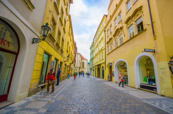 Prague, Czech Republic - 13 August, 2015: Very nice tight street around old town, bridgestone road and beautiful yellow facades — Stock Photo, Image