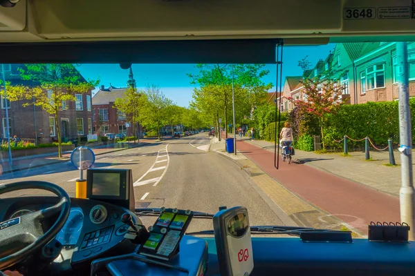 Harlem, Amsterdam, Netherlands - July 14, 2015: Inside public transportation bus in traffic, front seat view, driver on the left, nice sunny day — Stock Photo, Image