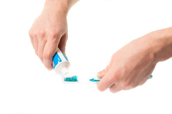 Toothbrush with toothpaste in the hand Stock Photo