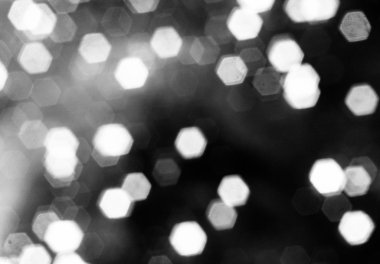 Siyah arka plan üzerinde parlak bokeh altıgen şekil