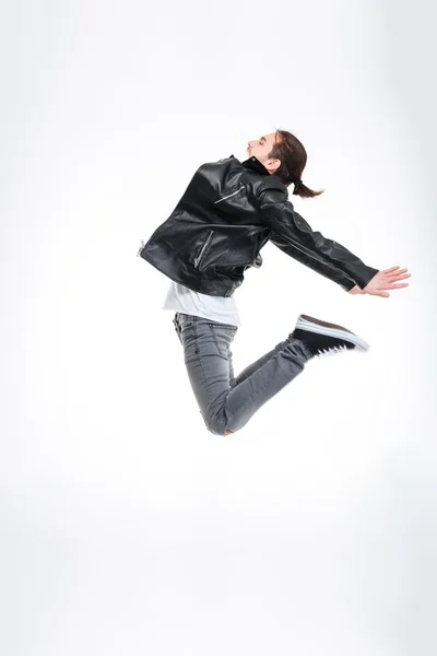 Attractive young man in black leather jacket jumping high — Stock Photo, Image