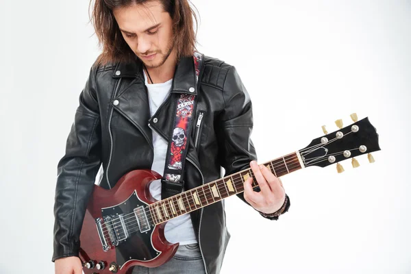 Handsome young man black leather jacket playing electric guitar — Stock Fotó