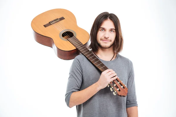 Handsome young man holding guitar on his shoulder — Φωτογραφία Αρχείου