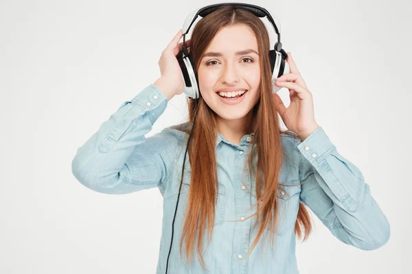 Feliz encantadora joven en auriculares escuchando música — Foto de Stock