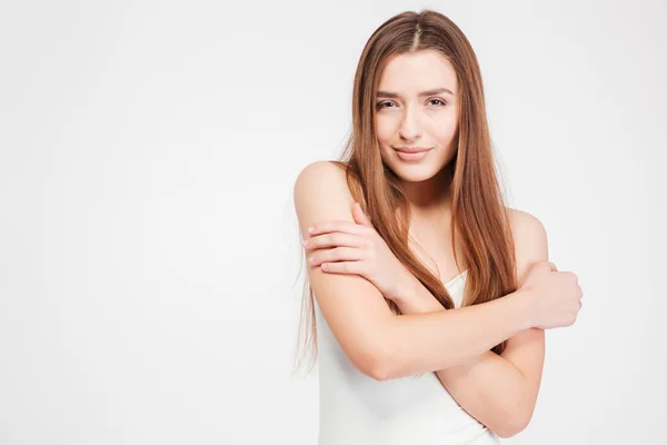 Attractive seductive young woman standing and hugging herself — Stock Photo, Image