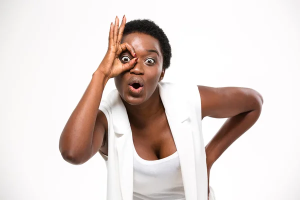 Amazed pretty african american woman making funny face with hand — Stockfoto