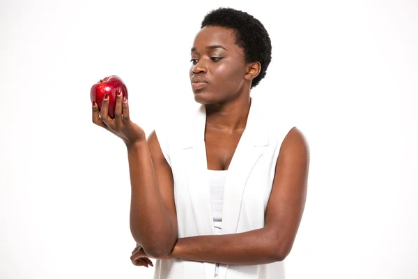 Pensive attractive african american young woman holding apple and thinking — Stock Fotó