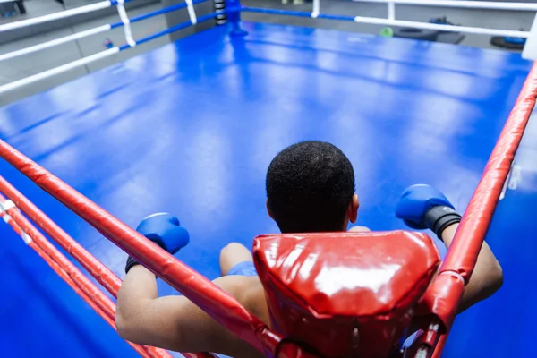 Boxer sentado no canto do ringue de boxe — Fotografia de Stock