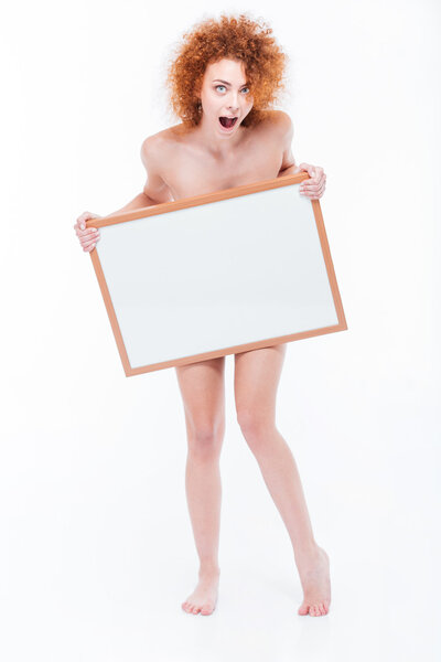 Shocked naked woman holding blank board