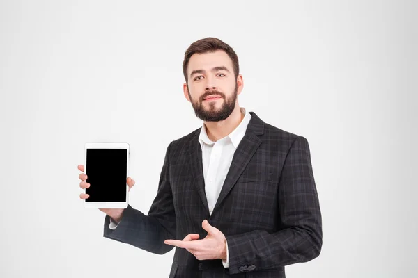 Businessman showing blank tablet computer screen — Stock Photo, Image