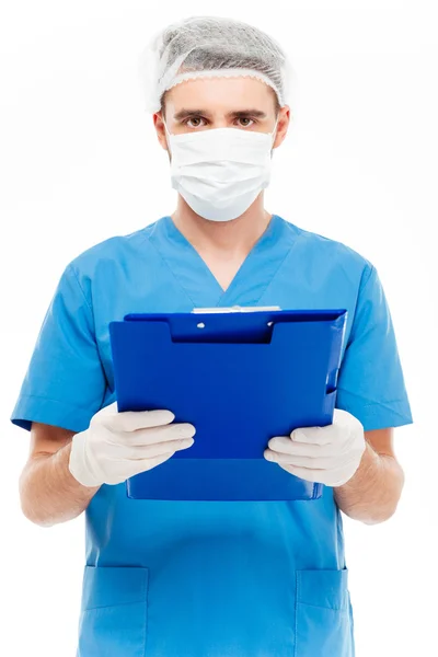 Male surgeon in mask holding clipboard — Stock Photo, Image