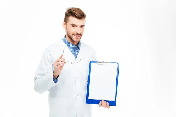 Male doctor showing blank clipboard — Stock Photo, Image