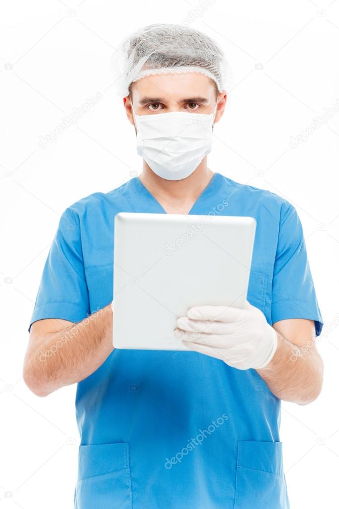 Male surgeon using tablet computer 