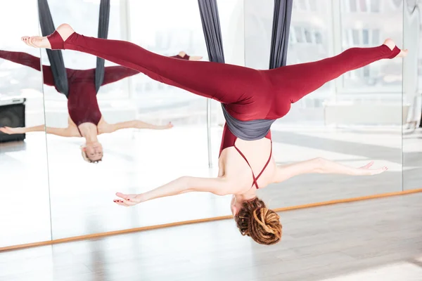 Woman doing pose of antigravity yoga using hammock — Stock Photo, Image