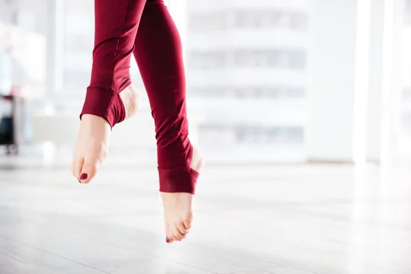 Beautiful slim legs of sportswoman in the air — Stock Photo, Image