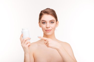 Woman pointing finger on bottle with pills