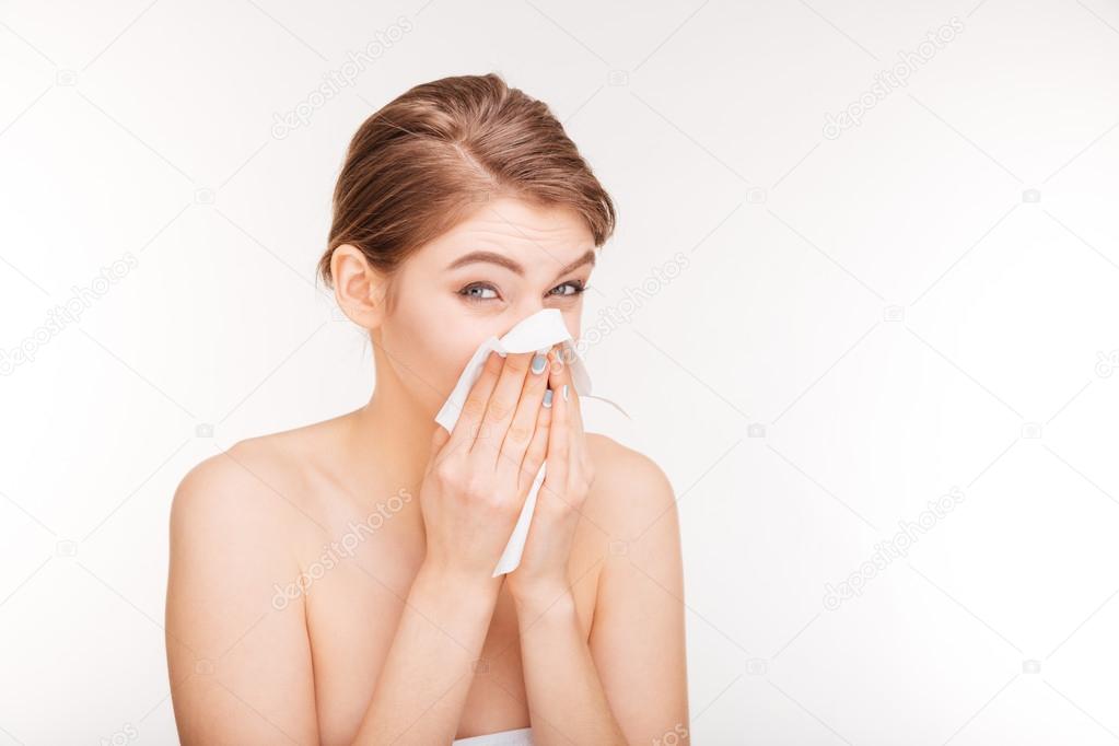 Unhappy young woman catched a cold and using paper handkerchief 