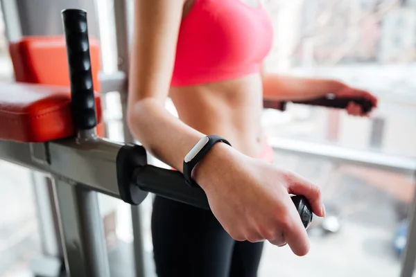Woman athlete with fitness tracker on hand working out — Stock Photo, Image