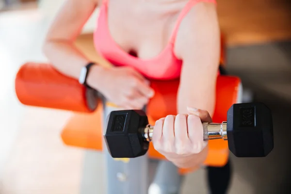 Closeup of metal dumbbell holded by young woman athlete — Stock Photo, Image