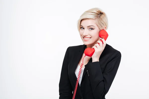 Mulher de negócios sorrindo falando no tubo de telefone — Fotografia de Stock
