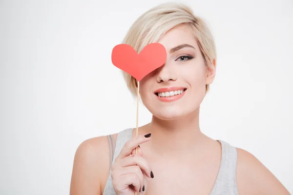 Smiling woman holding red heart — Stock Photo, Image